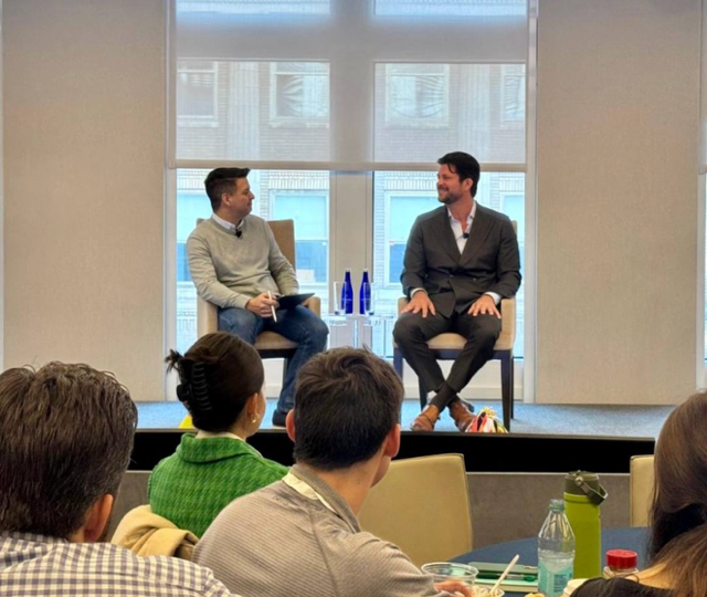 Steven Soares speaking on stage during an executive fireside interview