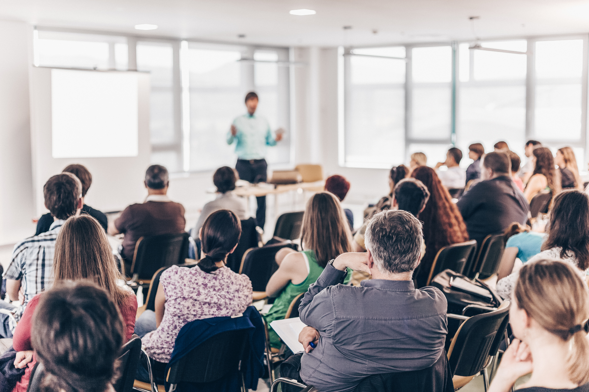 Faculty teaching a graduate-level seminar to engaged students